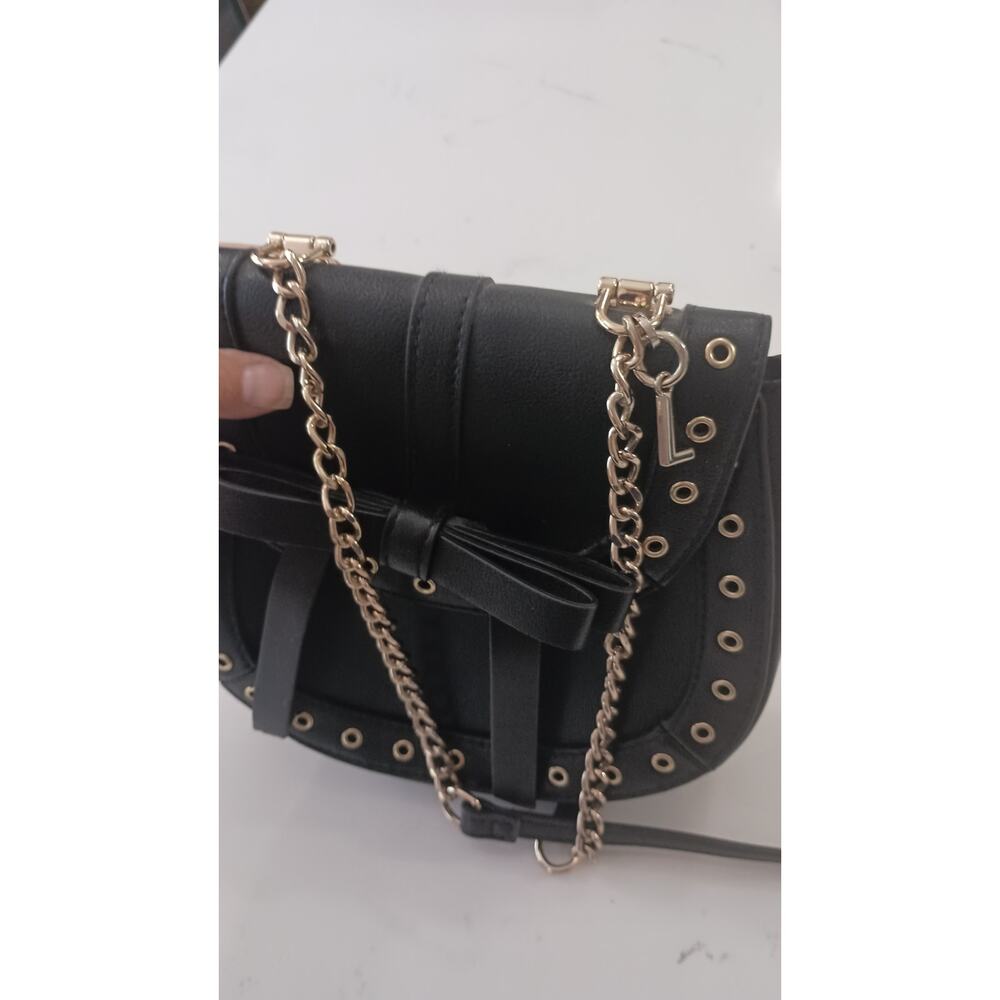The Express Black Crossbody embellished with Bow metal grommets flap  closure. - Picture 9 of 12
